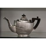 A small silver teapot.