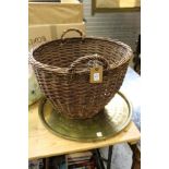 A wicker basket, eastern brass tray and a floor standing lamp.