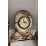 A small alabaster mantle clock.