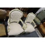 A pair of French style cream painted and upholstered open armchairs.