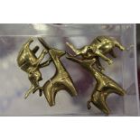 Four small bronze reindeer shaped place name holders.