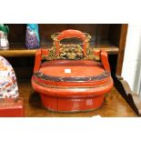 A Chinese red lacquer box with carved wood handle.