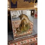 A mirror decorated with a lioness.