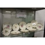 A quantity of Royal Copenhagen porcelain plates and serving dishes, cream ground with floral