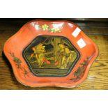 A Chinese red lacquer lobed bowl decorated with figures to the centre.