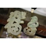 Two Chinese carved jade amulets.