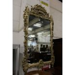 A large decorative silvered frame mirror.