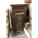 A carved oak pedestal cupboard.