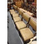 A set of six beech framed dining chairs with leather cloth upholstered backs and seats.