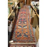 A good Persian runner / hall carpet, blue ground with stylized decoration.