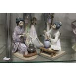 Two Lladro groups depicting seated geishas.