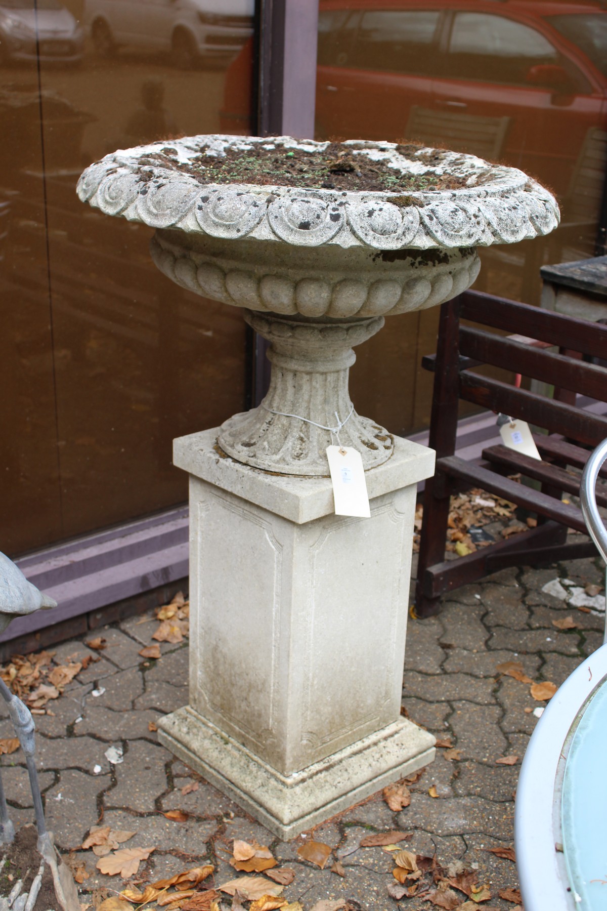 A good large reconstituted stone urn on a pedestal base.