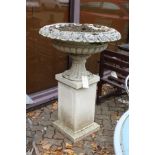 A good large reconstituted stone urn on a pedestal base.