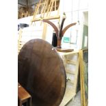 A mahogany circular breakfast table.