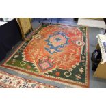 An eastern carpet, bright red ground with stylized blue, cream and green decoration (some wear).