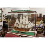 A large model of a gun ship "The Norske Love 1765" housed in a Perspex display case.