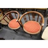 Two Edwardian mahogany horseshoe shaped occasional chairs.