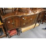 A mahogany serpentine fronted sideboard.