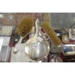 A plain silver backed hand mirror and two silver backed hand brushes.