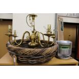 A wicker basket, a brass chandelier, a mini hi-fi.
