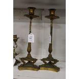 A good pair of ormolu candlesticks on concave sided bases.