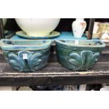 A pair of pottery wall planters.
