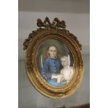 A good 19th century French oval portrait miniature of a mother and child in an ormolu easel frame.