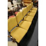 A set of six oak framed dining chairs with brass studded upholstered backs and seats.