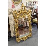 A Chinese Chippendale revival gilt framed pier mirror.