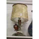 A table lamp, the base modelled as a kingfisher on a branch.