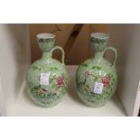 A pair of Copeland Spode floral decorated jugs (AF).