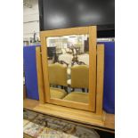 A modern light oak dressing table mirror.