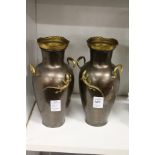 A pair of bronze colour metal vases.