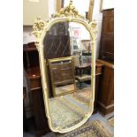 A large decoratively framed mirror.