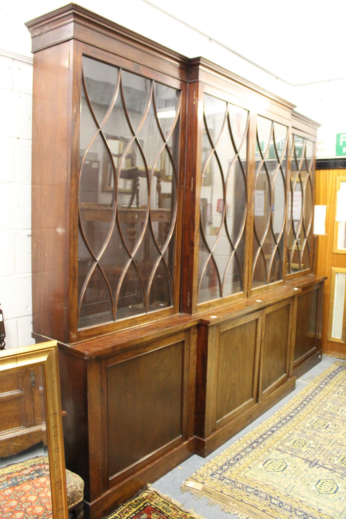 A good George III design mahogany breakfront library bookcase, early 20th century with four astragal