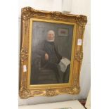 A portrait of an elderly gentleman seated in a chair oil on canvas in a decorative gilt frame.