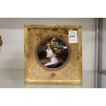 A good Limoges small circular enamel portrait plaque of a lady in a gilt frame.