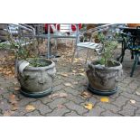 A pair of reconstituted stone garden pots.