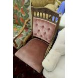 A Victorian oak framed and upholstered armchair.