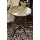 A 19th century oak circular tripod table.