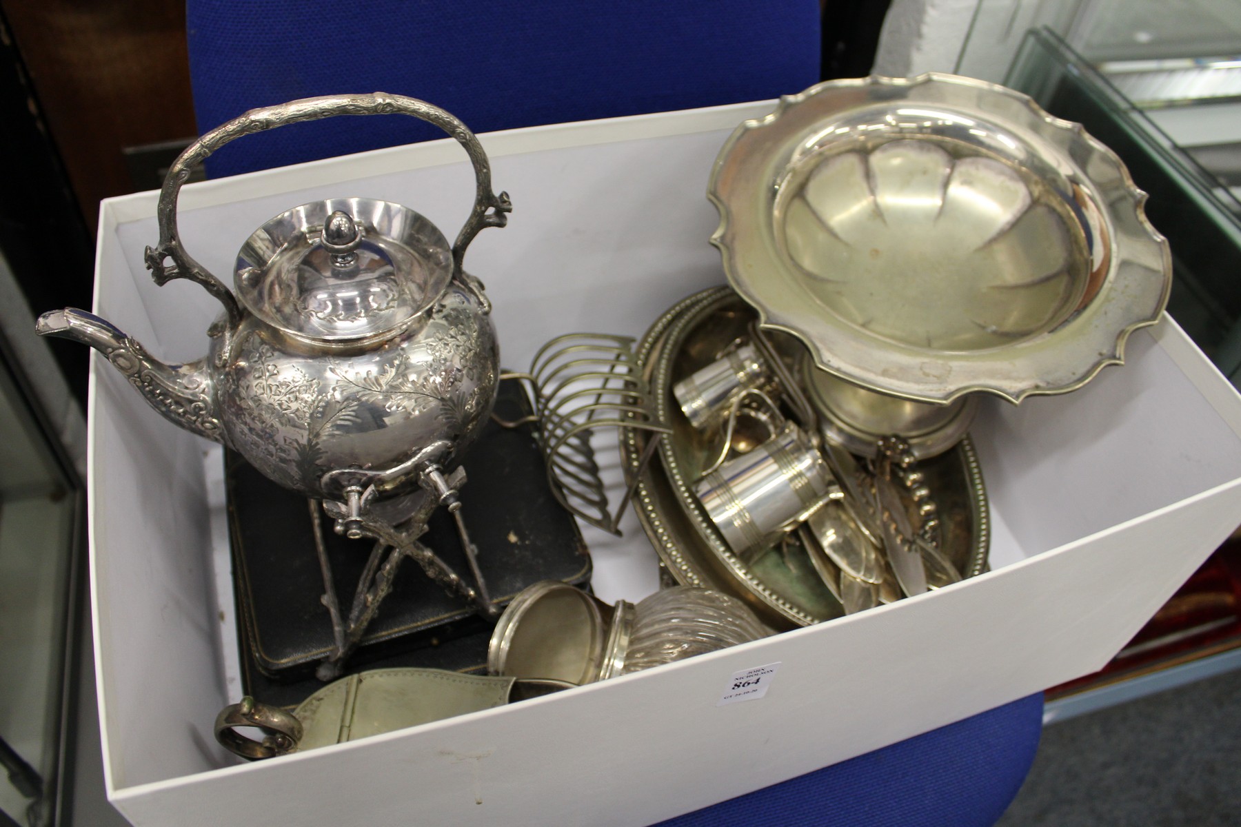 A plated kettle on stand and other items.