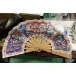 A good Chinese carved sandalwood and painted paper fan, in a lacquer case.