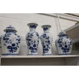 A garniture of blue and white vases and jars.