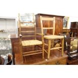 A child's rush seated armchair and a child's elm seated chair.