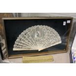 A framed and glazed lace fan.