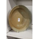 A Chinese tea dust glazed circular bowl.