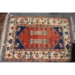 A Persian rug, central red ground decorated with two columns (some wear).