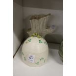 A Belleek honey bowl and cover and a similar vase.