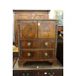 a 19th century mahogany commode with two doors and two long drawers on bracket feet.