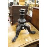 A Victorian tripod base of a music seat.